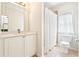 Well-lit bathroom with a vanity, mirror, and shower with curtain at 424 Melrose Ave, Decatur, GA 30030