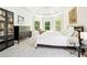 Bedroom with a tray ceiling, neutral carpet, and an adjacent bookcase at 424 Melrose Ave, Decatur, GA 30030