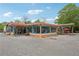 Eye-level view of a multi-tenant commercial building with colorful awnings and ample parking at 424 Melrose Ave, Decatur, GA 30030