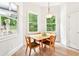 Cozy dining area with hardwood floors and windows offering backyard views at 424 Melrose Ave, Decatur, GA 30030