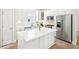 White kitchen with stainless steel appliances, bright countertops, and island at 424 Melrose Ave, Decatur, GA 30030