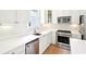 Bright kitchen featuring stainless steel appliances, white cabinets, and white countertops at 424 Melrose Ave, Decatur, GA 30030