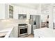 Kitchen with stainless appliances and white cabinets, and open concept layout at 424 Melrose Ave, Decatur, GA 30030