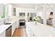 Bright kitchen with white cabinets, stainless appliances, island and open concept to the living room at 424 Melrose Ave, Decatur, GA 30030