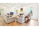 Open concept living room with hardwood floors, fireplace, and backyard view at 424 Melrose Ave, Decatur, GA 30030