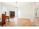 Bright living room with hardwood floors, piano, and glass display cabinet at 424 Melrose Ave, Decatur, GA 30030