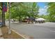 Distant view of a tent covered patio and brick pergola dining at The Marlay on a tree lined street at 424 Melrose Ave, Decatur, GA 30030