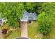 Aerial view of a home and driveway surrounded by lush greenery and trees at 4822 Westbourne Dr, Powder Springs, GA 30127
