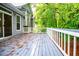 Inviting back deck with white railing offers a serene outdoor space surrounded by lush trees at 4822 Westbourne Dr, Powder Springs, GA 30127