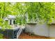Back exterior view of home with a deck, stairs and lush greenery at 4822 Westbourne Dr, Powder Springs, GA 30127