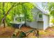 Back exterior view of home with a deck, stairs and lush greenery at 4822 Westbourne Dr, Powder Springs, GA 30127