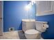 Bathroom with window, white vanity, and toilet at 4822 Westbourne Dr, Powder Springs, GA 30127