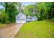 Charming two-story home with a lush green lawn and a two car garage at 4822 Westbourne Dr, Powder Springs, GA 30127
