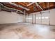 Spacious garage with white doors, concrete floor, and exposed wood rafters providing a rustic feel at 4822 Westbourne Dr, Powder Springs, GA 30127