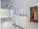 Kitchen area with a white island, modern dishwasher, sink, and view of the staircase at 4822 Westbourne Dr, Powder Springs, GA 30127