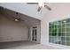 Spacious living room with high ceilings, ceiling fan, large windows, and sliding glass doors to a deck at 4822 Westbourne Dr, Powder Springs, GA 30127