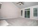 Large living room features vaulted ceilings, a ceiling fan, big windows, and sliding glass doors at 4822 Westbourne Dr, Powder Springs, GA 30127