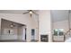 Spacious living room featuring vaulted ceiling, ceiling fan, fireplace, and large windows for natural light at 4822 Westbourne Dr, Powder Springs, GA 30127