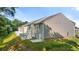 Backyard view of a townhome showcasing the green lawn, a patio, and privacy fences on a sunny day at 339 Elgin Dr, Lawrenceville, GA 30045