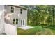 A view of the backyard of a townhome featuring a small patio and a grassy area, bordered by a white fence at 339 Elgin Dr, Lawrenceville, GA 30045