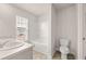 Bright bathroom featuring a double sink vanity and a tub shower combination near a window at 339 Elgin Dr, Lawrenceville, GA 30045