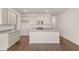 Kitchen featuring an island, stainless steel appliances, granite countertops, and hardwood floors at 339 Elgin Dr, Lawrenceville, GA 30045