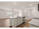 Open-concept kitchen flows into the living space with hardwood floors and modern finishes at 339 Elgin Dr, Lawrenceville, GA 30045
