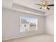 Main bedroom with carpet flooring, ceiling fan, and a large window at 339 Elgin Dr, Lawrenceville, GA 30045