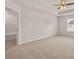 Spacious main bedroom with neutral carpet, a ceiling fan, and a bathroom entrance at 339 Elgin Dr, Lawrenceville, GA 30045