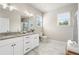 Bright bathroom featuring a double vanity with granite countertop and elegant marble floors at 5128 Noble Village Way # 35, Lilburn, GA 30047