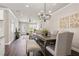 Spacious dining area with seating for six, contemporary lighting, and an open flow to the living space at 5128 Noble Village Way # 35, Lilburn, GA 30047