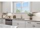 Charming kitchen featuring white cabinets, granite countertops, tile backsplash, and stainless steel appliances at 5128 Noble Village Way # 35, Lilburn, GA 30047
