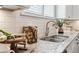 New kitchen with granite countertops, white cabinets, stainless steel faucet, and subway tile backsplash at 5128 Noble Village Way # 35, Lilburn, GA 30047