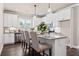 Bright kitchen with white cabinetry, stainless steel appliances, granite counters, and stylish pendant lighting at 5128 Noble Village Way # 35, Lilburn, GA 30047
