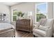 Main bedroom features a dresser, chair, natural light and hardwood floors at 5128 Noble Village Way # 35, Lilburn, GA 30047