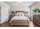 Beautiful main bedroom features hardwood floors, modern decor, and natural light at 5128 Noble Village Way # 35, Lilburn, GA 30047