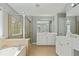 Bathroom featuring a glass shower, soaking tub, double vanity, and lots of light at 1530 Wehunt Se Cir # 19, Smyrna, GA 30082