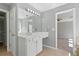 Bathroom view showcasing white cabinets, tiled floors, and a large mirror with vanity lighting at 1530 Wehunt Se Cir # 19, Smyrna, GA 30082
