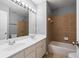 Bathroom showcasing double sinks, vanity, tile backsplash and a tub with shower at 1530 Wehunt Se Cir # 19, Smyrna, GA 30082