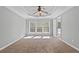 Spacious bedroom with large windows, a ceiling fan, and tray ceiling at 1530 Wehunt Se Cir # 19, Smyrna, GA 30082