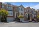 Charming townhomes featuring brick facade, two-car garages, manicured lawns, and architectural detail at 1530 Wehunt Se Cir # 19, Smyrna, GA 30082