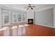 Bright living room featuring a fireplace, large windows, and a ceiling fan at 1530 Wehunt Se Cir # 19, Smyrna, GA 30082