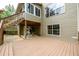 Back of house featuring wooden deck, walk-out basement, staircase to upper level, and workout equipment at 2055 Springer Walk, Lawrenceville, GA 30043