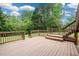 Exterior shot of a well-kept wooden deck with railings and stairs down to the backyard at 2055 Springer Walk, Lawrenceville, GA 30043