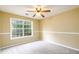 Bedroom featuring chair rail, ceiling fan and carpeted flooring at 2055 Springer Walk, Lawrenceville, GA 30043