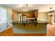 Open-concept kitchen with an expansive island, wood cabinetry, and views into adjacent rooms at 2055 Springer Walk, Lawrenceville, GA 30043