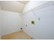 Dedicated laundry room space with utility connections and a wire shelf for storage solutions at 2055 Springer Walk, Lawrenceville, GA 30043
