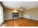 Living room with wood floors, a fireplace and a ceiling fan at 2055 Springer Walk, Lawrenceville, GA 30043
