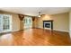 Open-concept living room with fireplace and a large bright window at 2055 Springer Walk, Lawrenceville, GA 30043