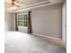 Large carpeted bedroom with a ceiling fan and tray ceiling at 2055 Springer Walk, Lawrenceville, GA 30043